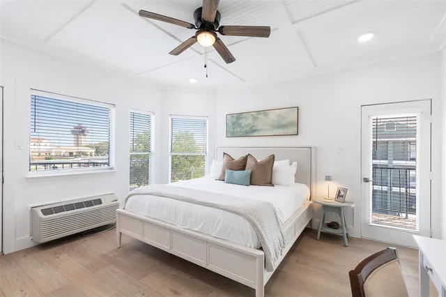 a bedroom with a bed wooden floor and window