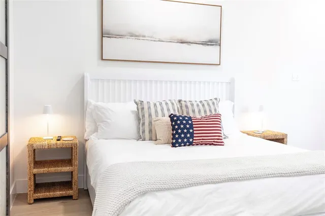 a bedroom with a large bed and a flat screen tv