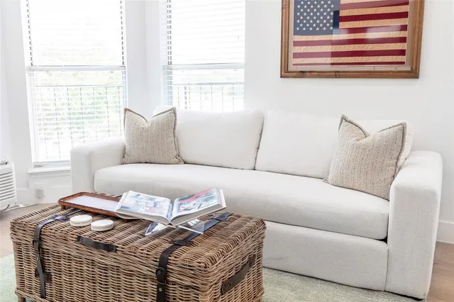a living room with a couch and windows