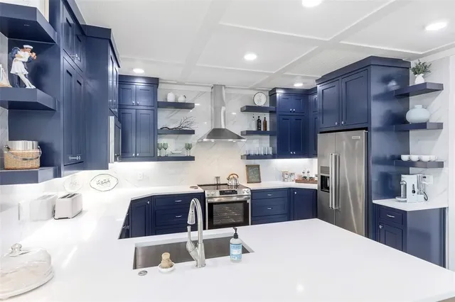 a kitchen with stainless steel appliances a table and chairs