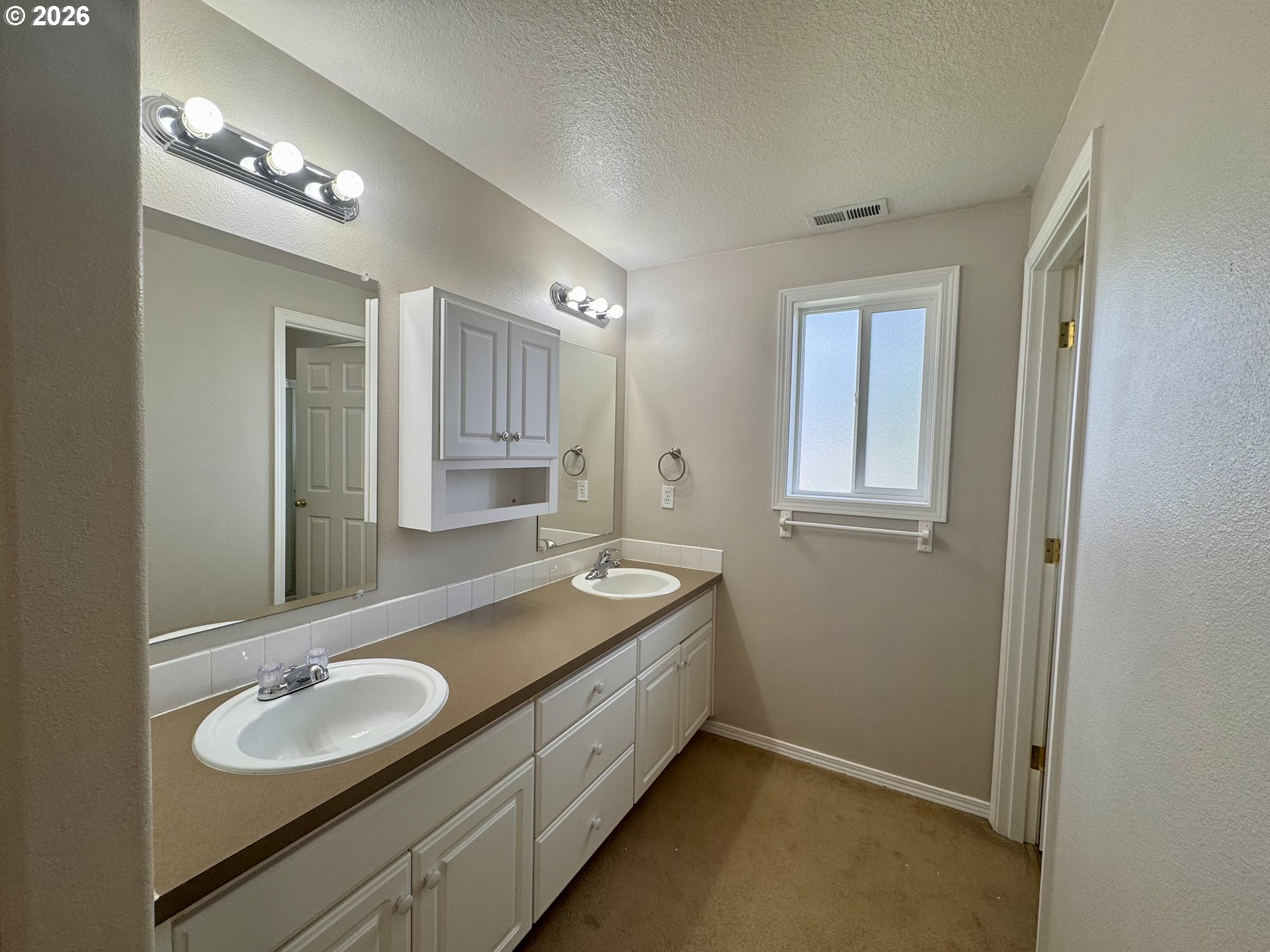310 13th Street Lafayette, OR 97127 - Photo 17 of 22 a bathroom with a granite countertop double vanity sink and a mirror
