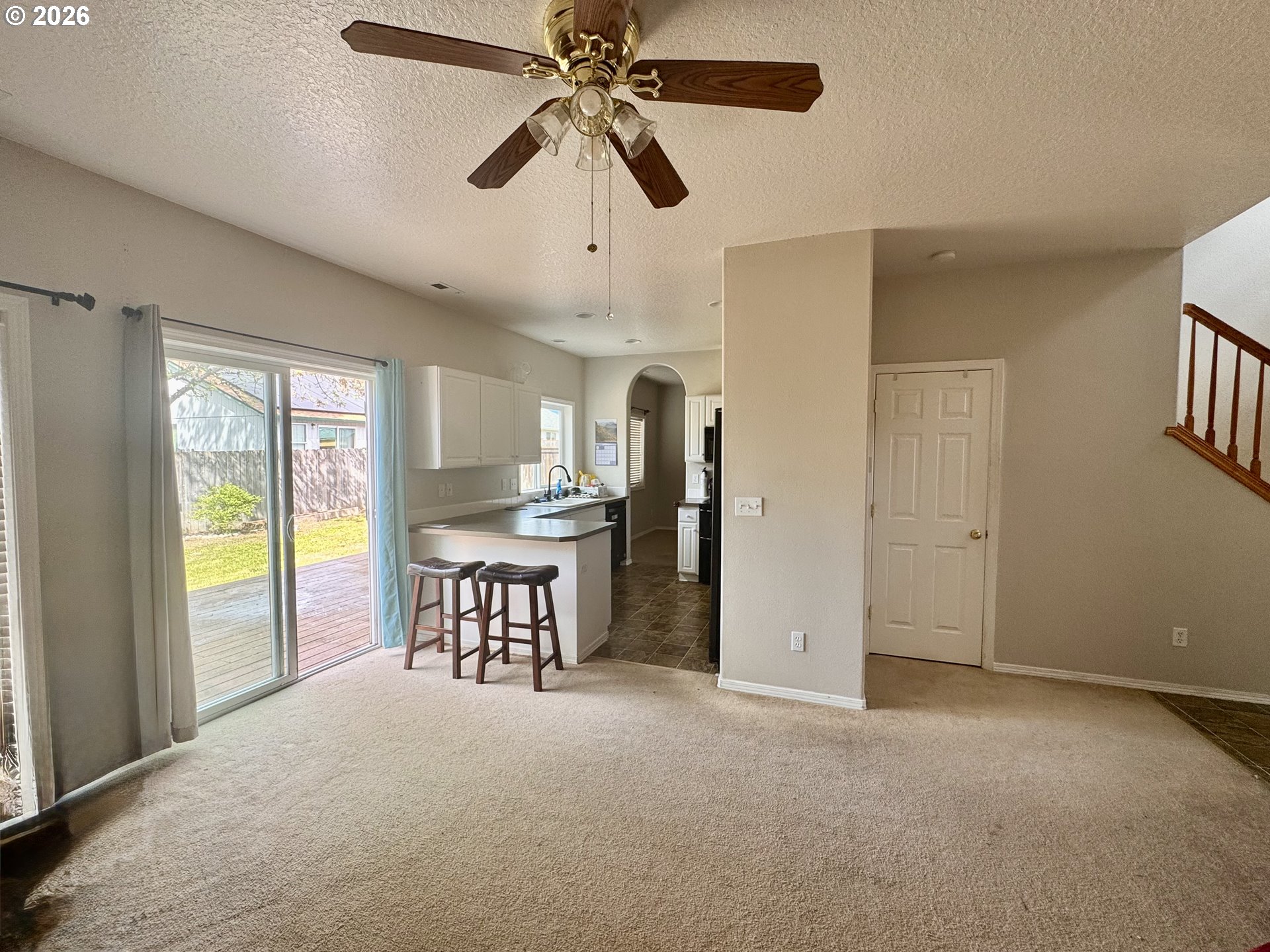 310 13th Street Lafayette, OR 97127 - Photo 4 of 22 a view of a livingroom with a furniture ceiling fan and windows