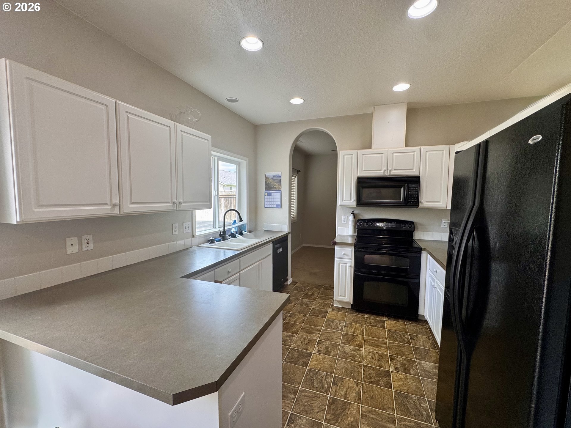 310 13th Street Lafayette, OR 97127 - Photo 5 of 22 a kitchen with stainless steel appliances granite countertop a refrigerator a stove and a sink