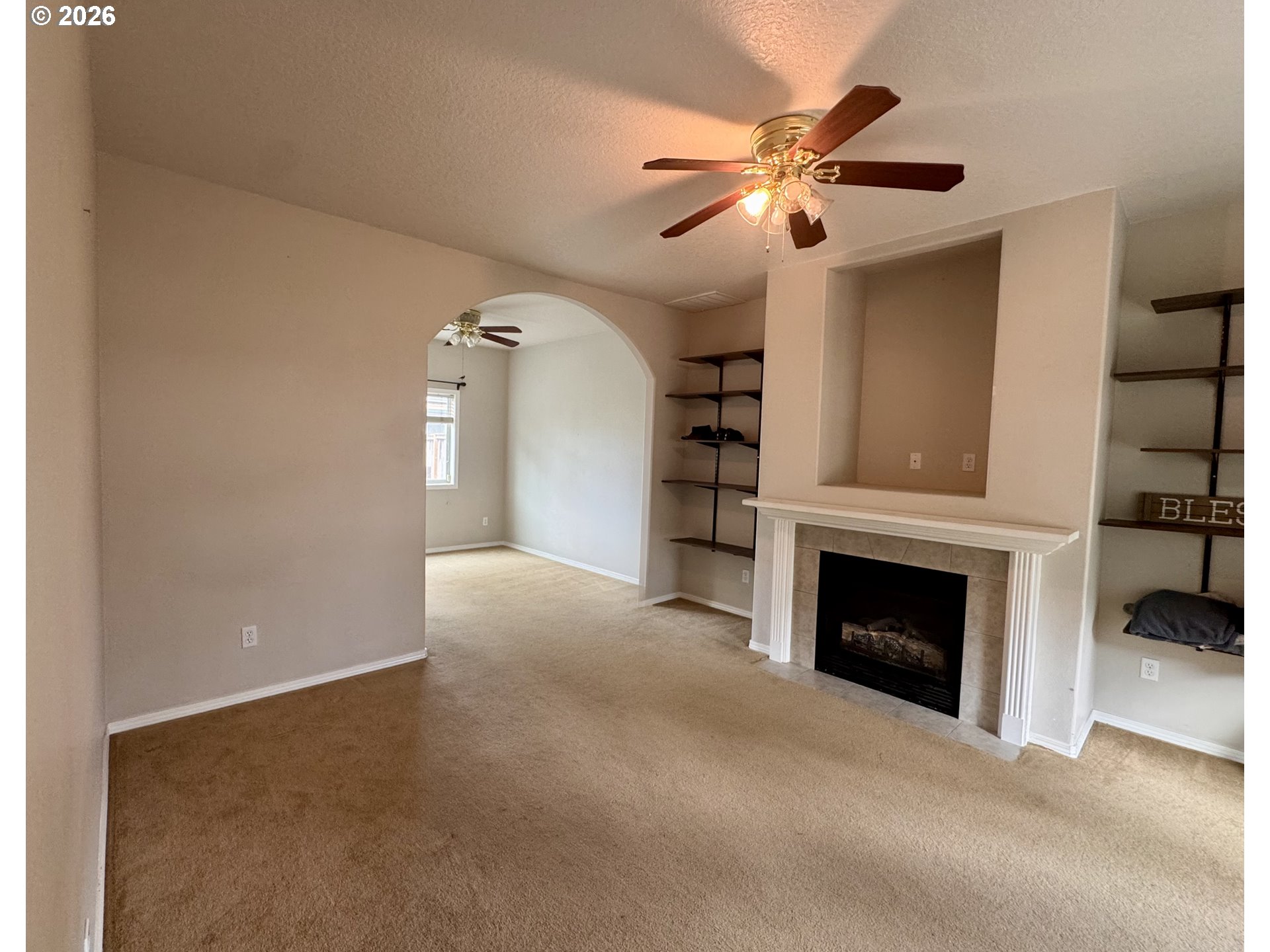 310 13th Street Lafayette, OR 97127 - Photo 8 of 22 a view of an empty room with chandelier fan and fire place