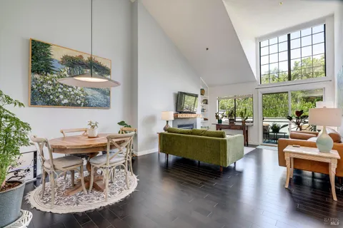 a living room with furniture a table and a large window