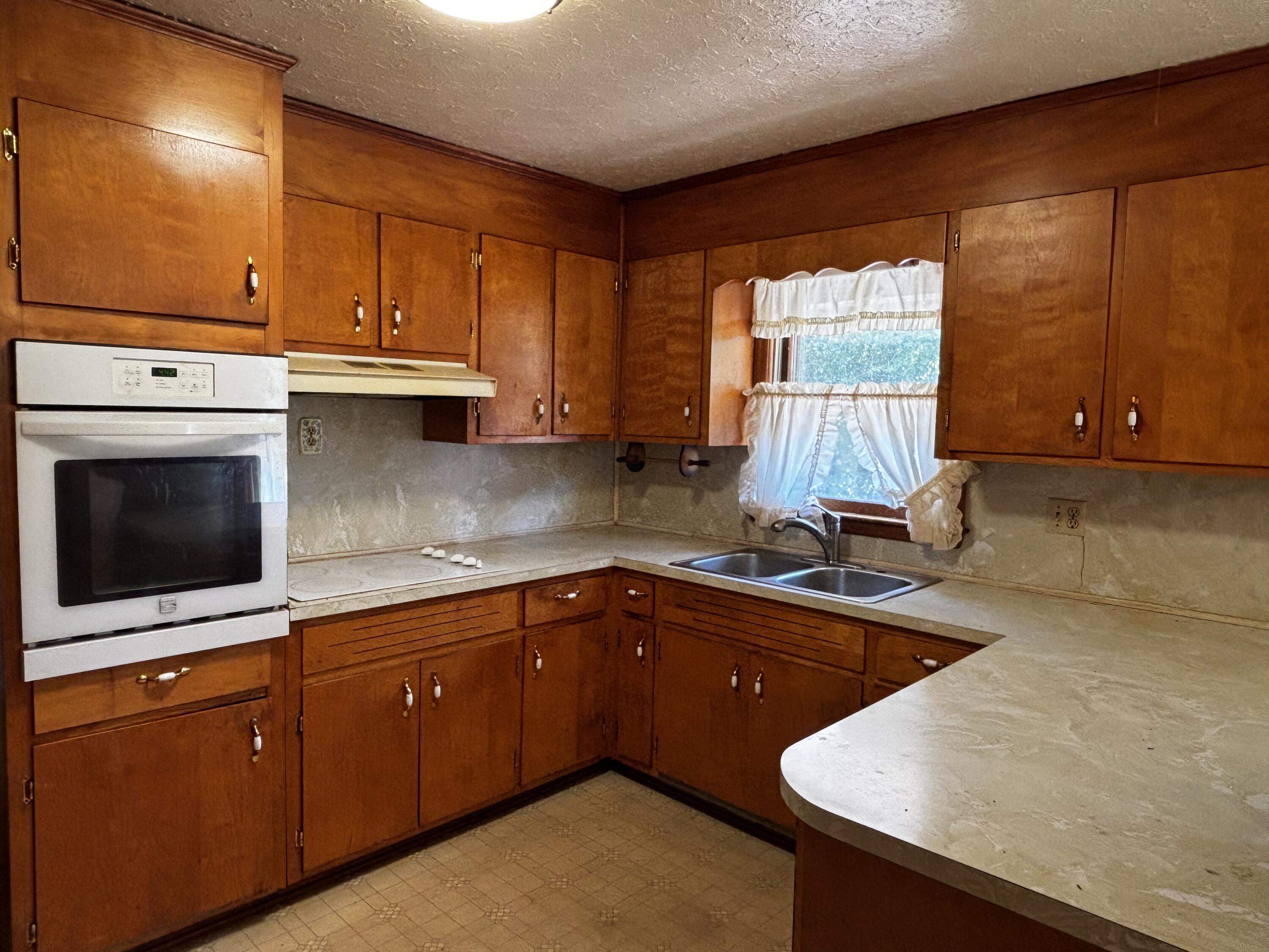375 Barberry Road Southeast Floyd, VA 24091 - Photo 19 of 40 a kitchen with stainless steel appliances a sink a stove a microwave a sink and cabinets