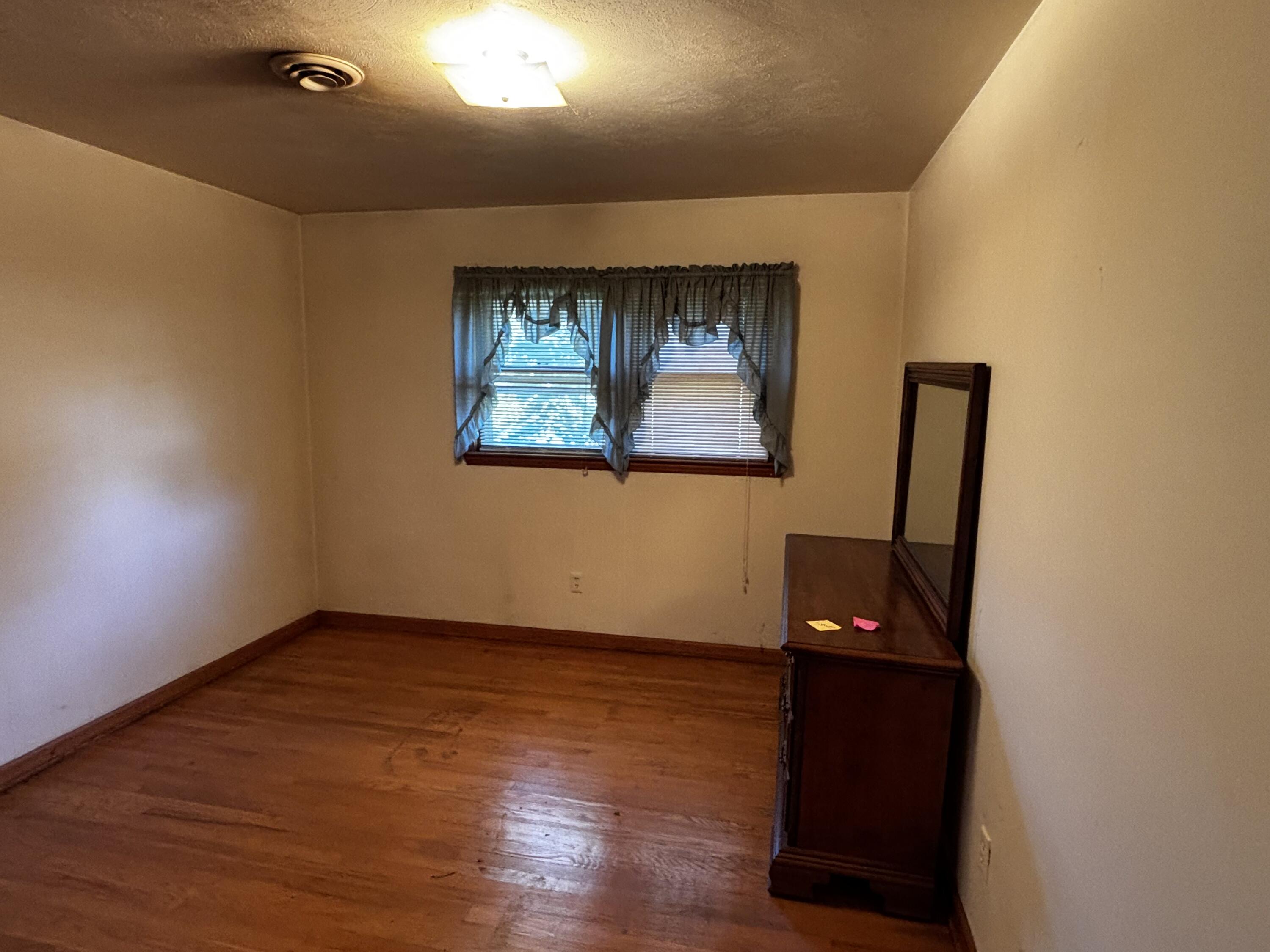 375 Barberry Road Southeast Floyd, VA 24091 - Photo 29 of 40 an empty room with wooden floor and windows