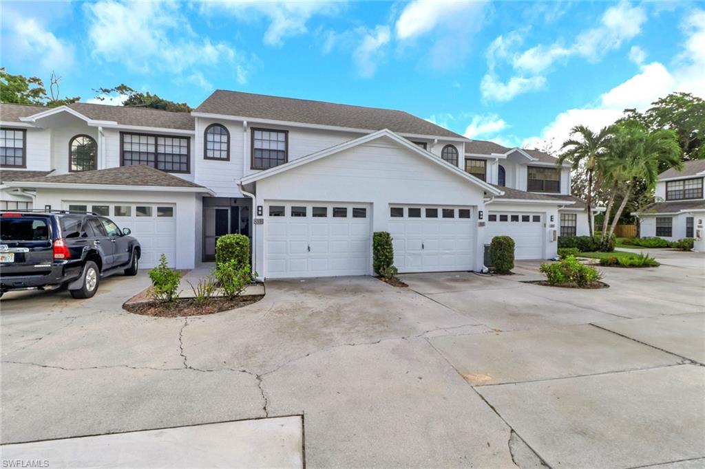 a front view of a building with a garden and fire pit