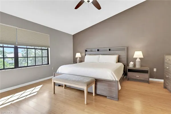 a bedroom with a bed and a large window