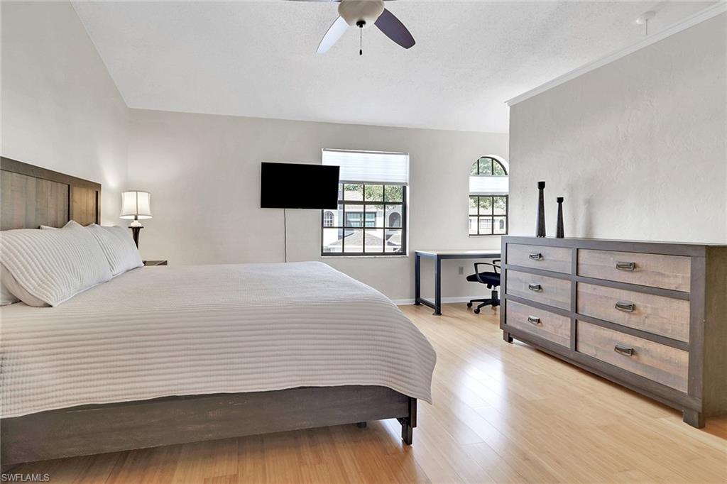 800 Meadowland Drive, Unit 252 Naples, FL 34108 - Photo 14 of 21 a bedroom with a large bed and a tv