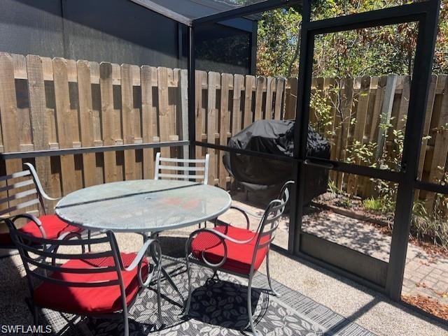 800 Meadowland Drive, Unit 252 Naples, FL 34108 - Photo 9 of 21 a view of a chairs and table in the balcony