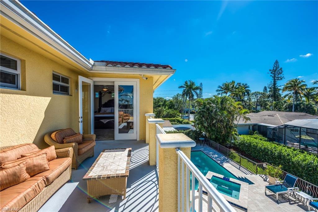 1672 Jewel Naples, FL 34102 - Photo 15 of 27 a view of a patio with couches table and chairs and potted plants