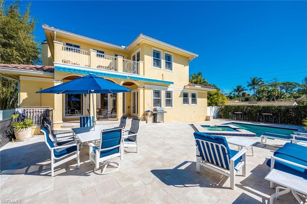 1672 Jewel Naples, FL 34102 - Photo 20 of 27 a view of a patio with a table and chairs under an umbrella