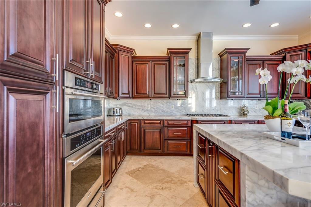 1672 Jewel Naples, FL 34102 - Photo 9 of 27 a kitchen with stainless steel appliances granite countertop a sink and a stove