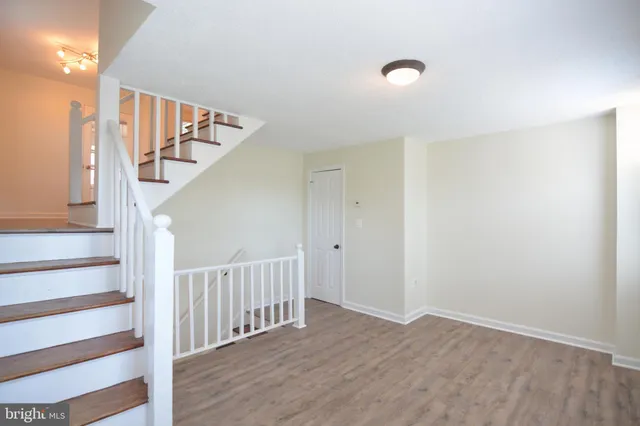 a kitchen with granite countertop a refrigerator stove and sink