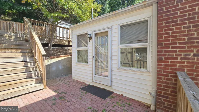 a view of a house with backyard and wooden fence