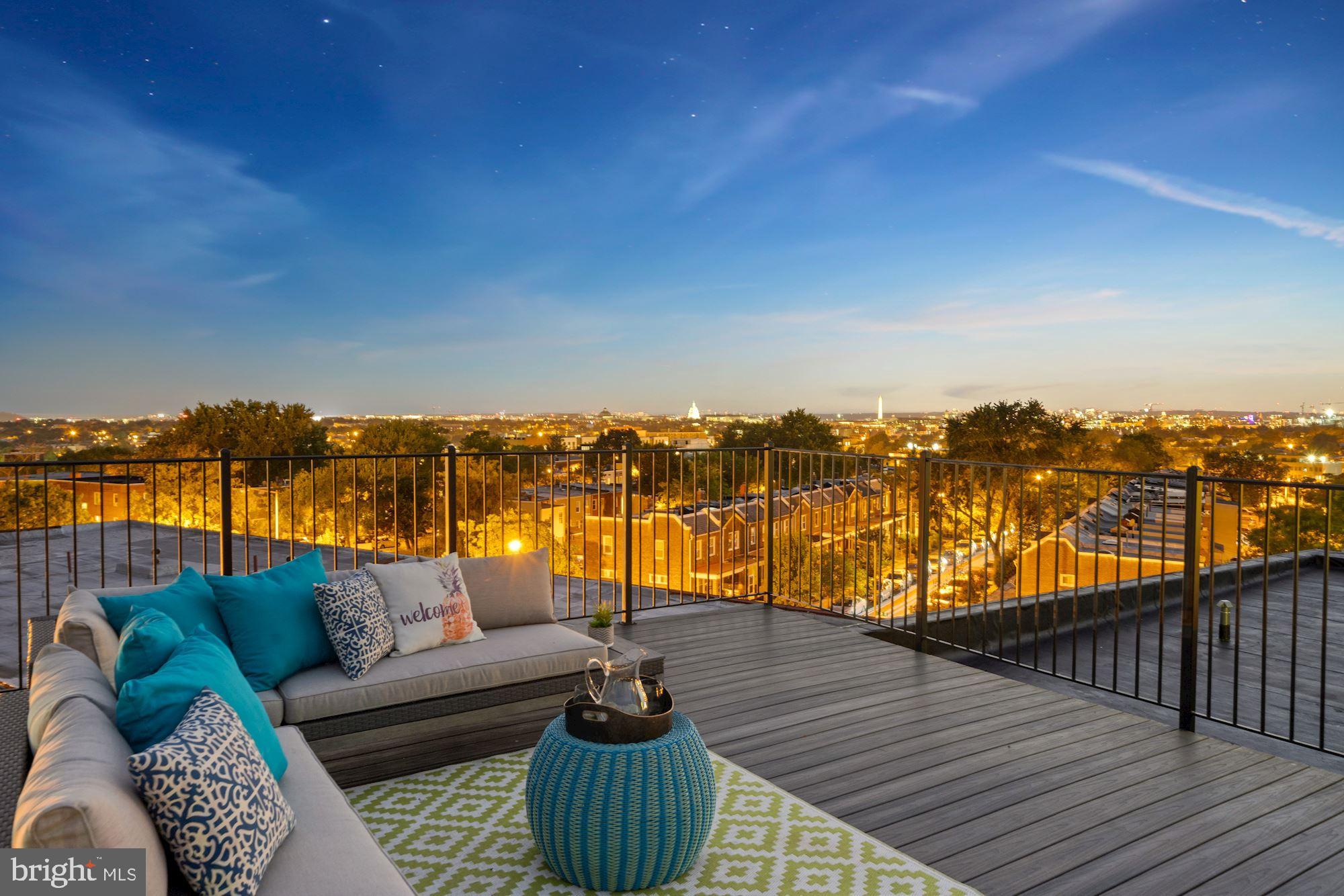 a balcony with furniture and city view