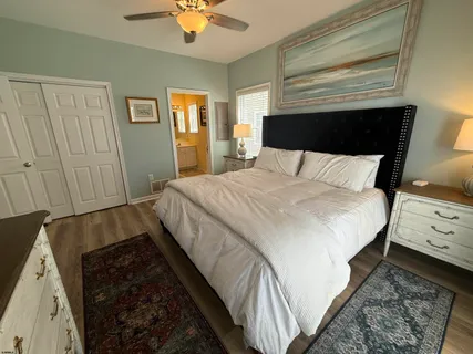 a bedroom with a bed and a night stand