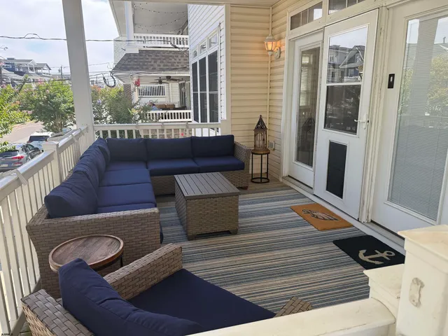 a balcony with wooden floor and furniture