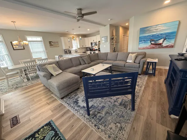 a living room with furniture a rug and a painting on the wall