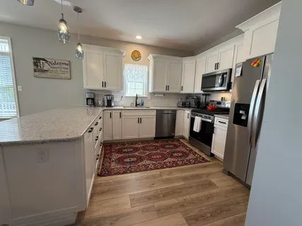 a kitchen with a sink stove and refrigerator