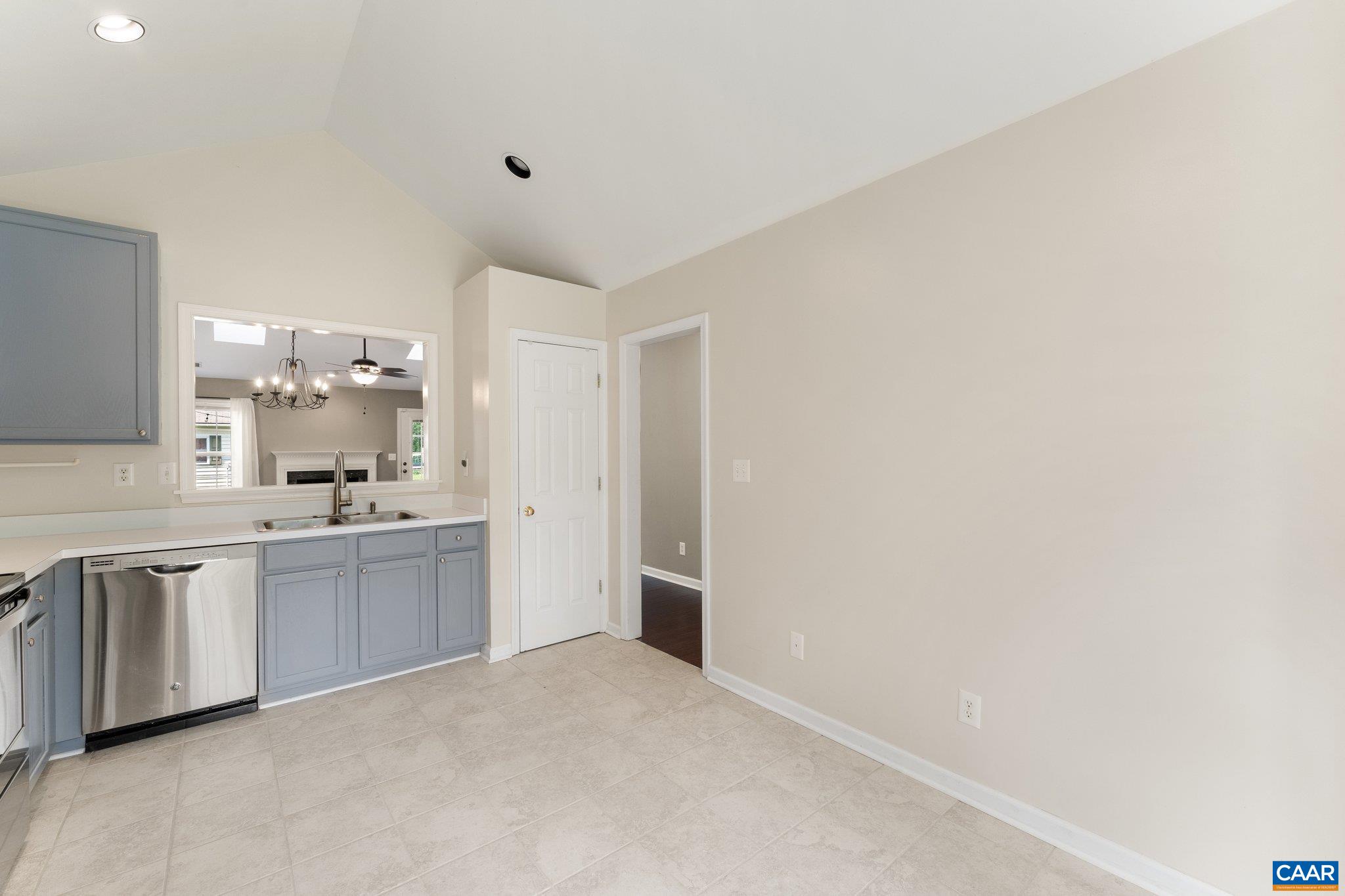 507 Northridge Road Ruckersville, VA 22968 - Photo 15 of 48 a large white kitchen with a sink and dishwasher a stove top oven with wooden floor