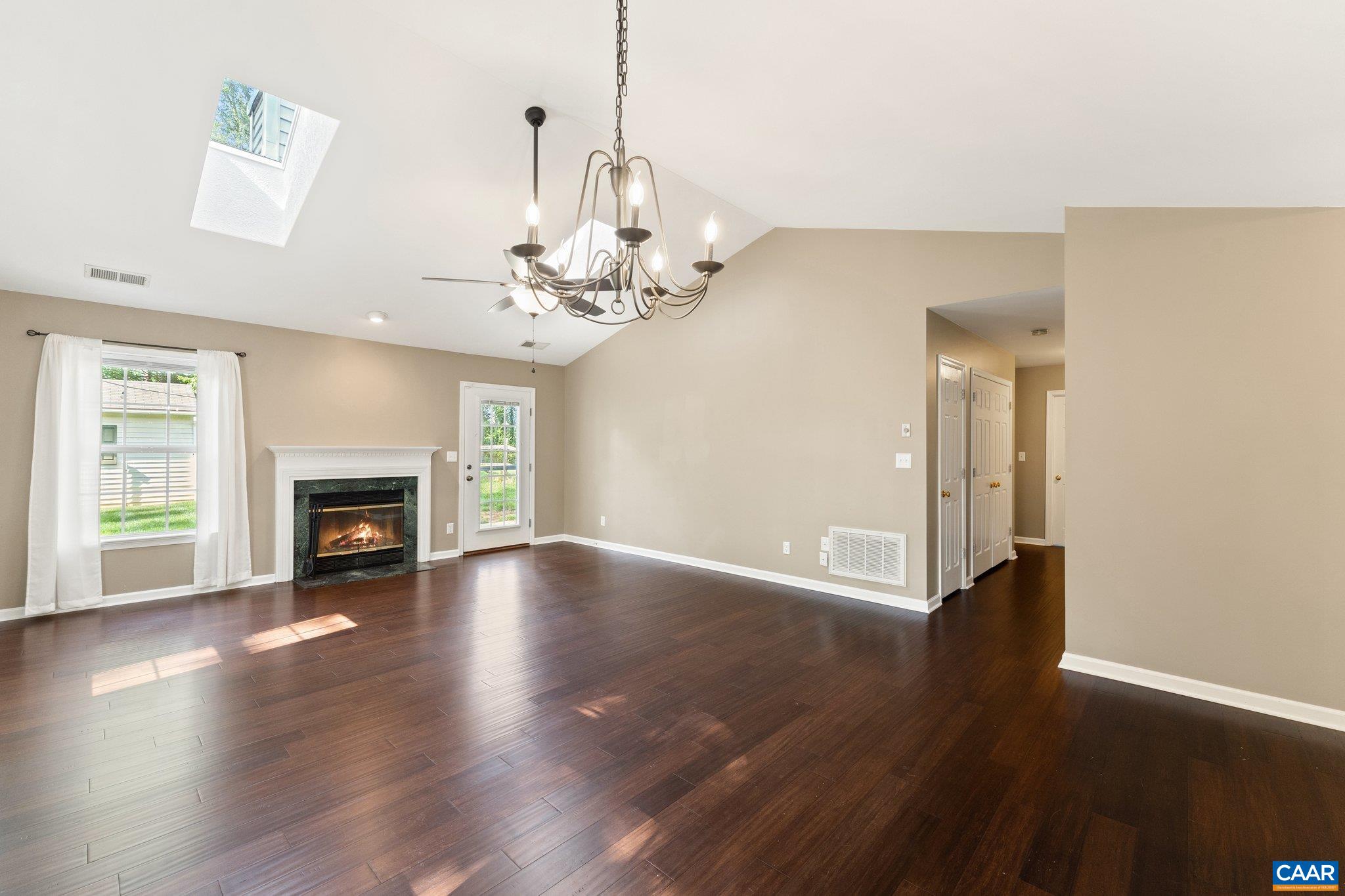 507 Northridge Road Ruckersville, VA 22968 - Photo 19 of 48 a view of an empty room with wooden floor and a fireplace