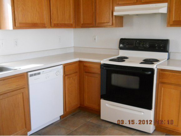 1350 West Antelope Run Road Paulden, AZ 86334 - Photo 9 of 11 a stove top oven sitting inside of a kitchen