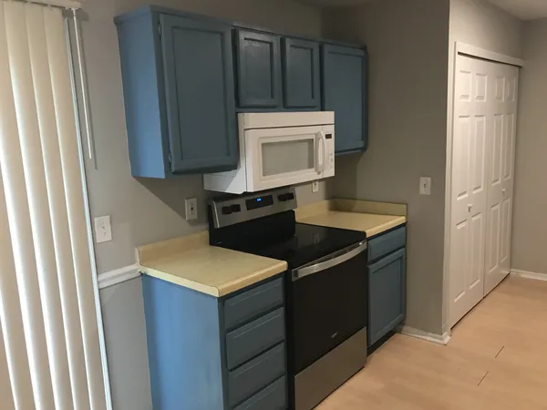 a kitchen with a sink and a stove top oven