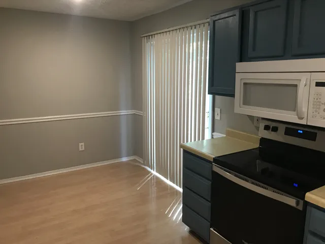 a kitchen with granite countertop cabinets and black appliances