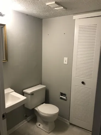 a white toilet sitting next to a bathroom sink