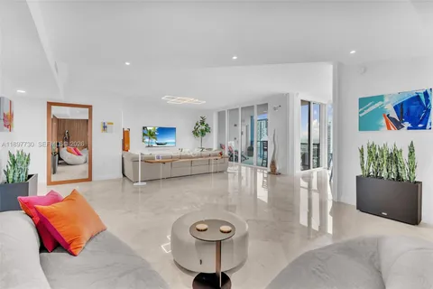a living room with furniture and large windows