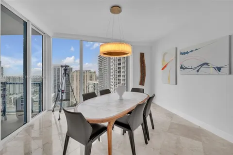 a large living room with stainless steel appliances kitchen island granite countertop furniture and a large window