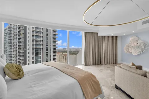 a very nice looking room with gym equipment and large windows