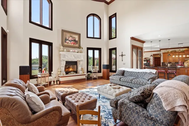 a large kitchen with kitchen island granite countertop a large window and cabinets