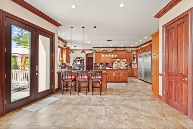 a living room with furniture a potted plant and a large window