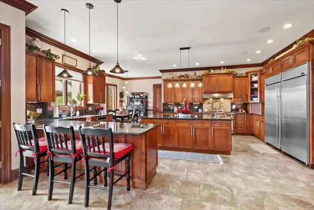a living room with furniture fireplace and a large window
