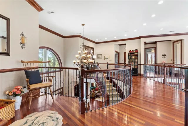 a spacious bedroom with a bed and glass window