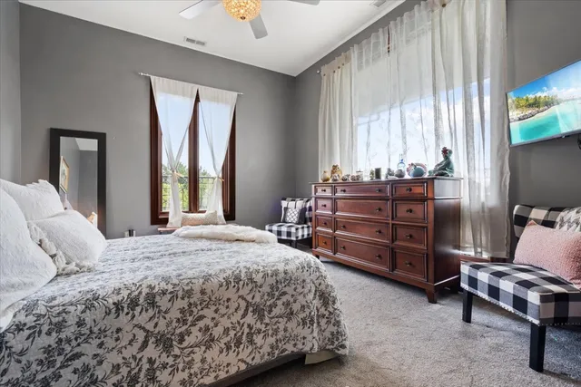 an aerial view of a house with swimming pool and large trees
