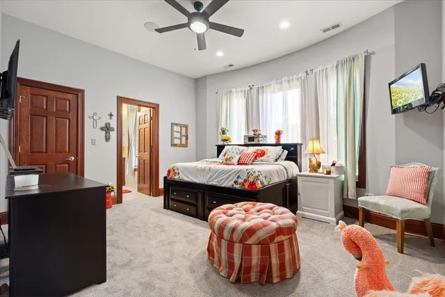 an aerial view of a house with swimming pool and large trees