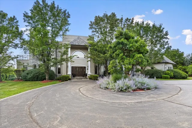 a living room with patio furniture and a large window