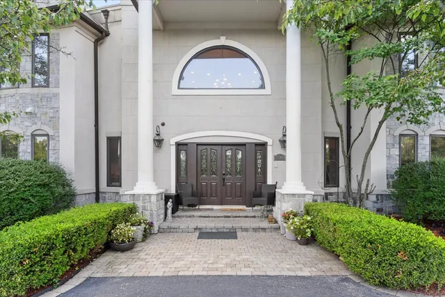a living room with furniture large window and a fireplace