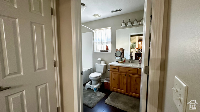 929 West 1920 South, Unit A Syracuse, UT 84075 - Photo 12 of 26 Full bathroom with vanity, hardwood / wood-style flooring, toilet, and washtub / shower combination