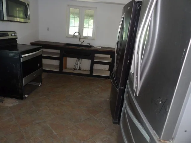 a view of a livingroom with furniture and staircase