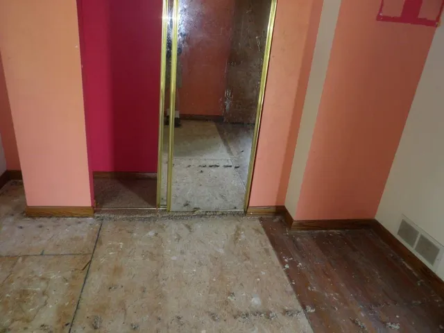 a view of a room with wooden floor