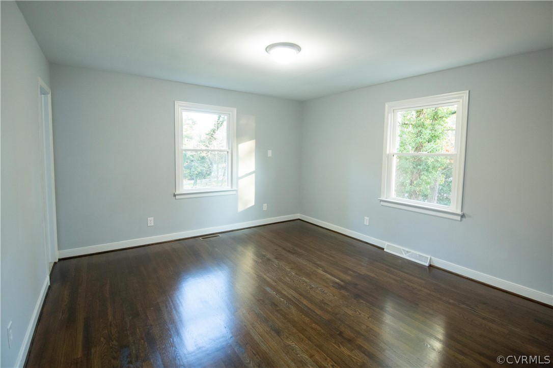 8530 Cherokee Road Richmond, VA 23235 - Photo 20 of 40 a view of an empty room with wooden floor and a window