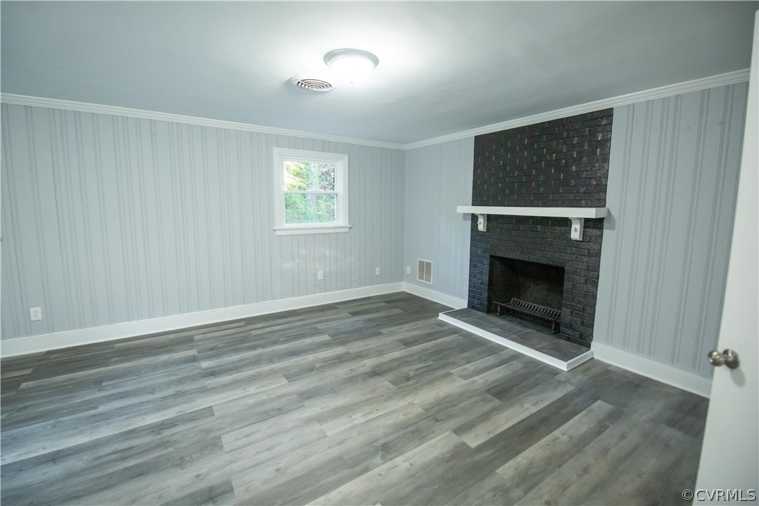 8530 Cherokee Road Richmond, VA 23235 - Photo 30 of 40 a view of empty room with wooden floor and fireplace