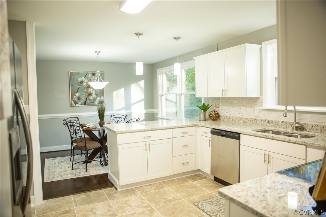 8530 Cherokee Road Richmond, VA 23235 - Photo 3 of 40 a kitchen with a sink chairs and cabinets