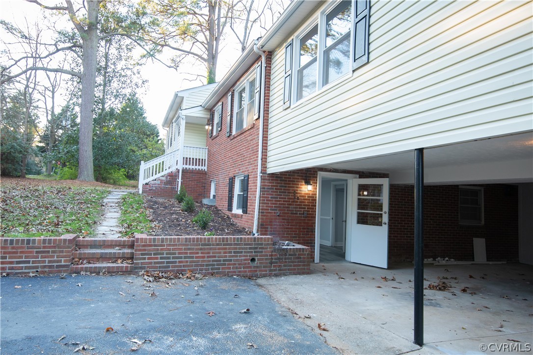 8530 Cherokee Road Richmond, VA 23235 - Photo 35 of 40 a view of a house with a yard and potted plants
