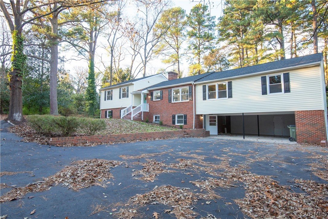 8530 Cherokee Road Richmond, VA 23235 - Photo 36 of 40 a front view of a house with a garden